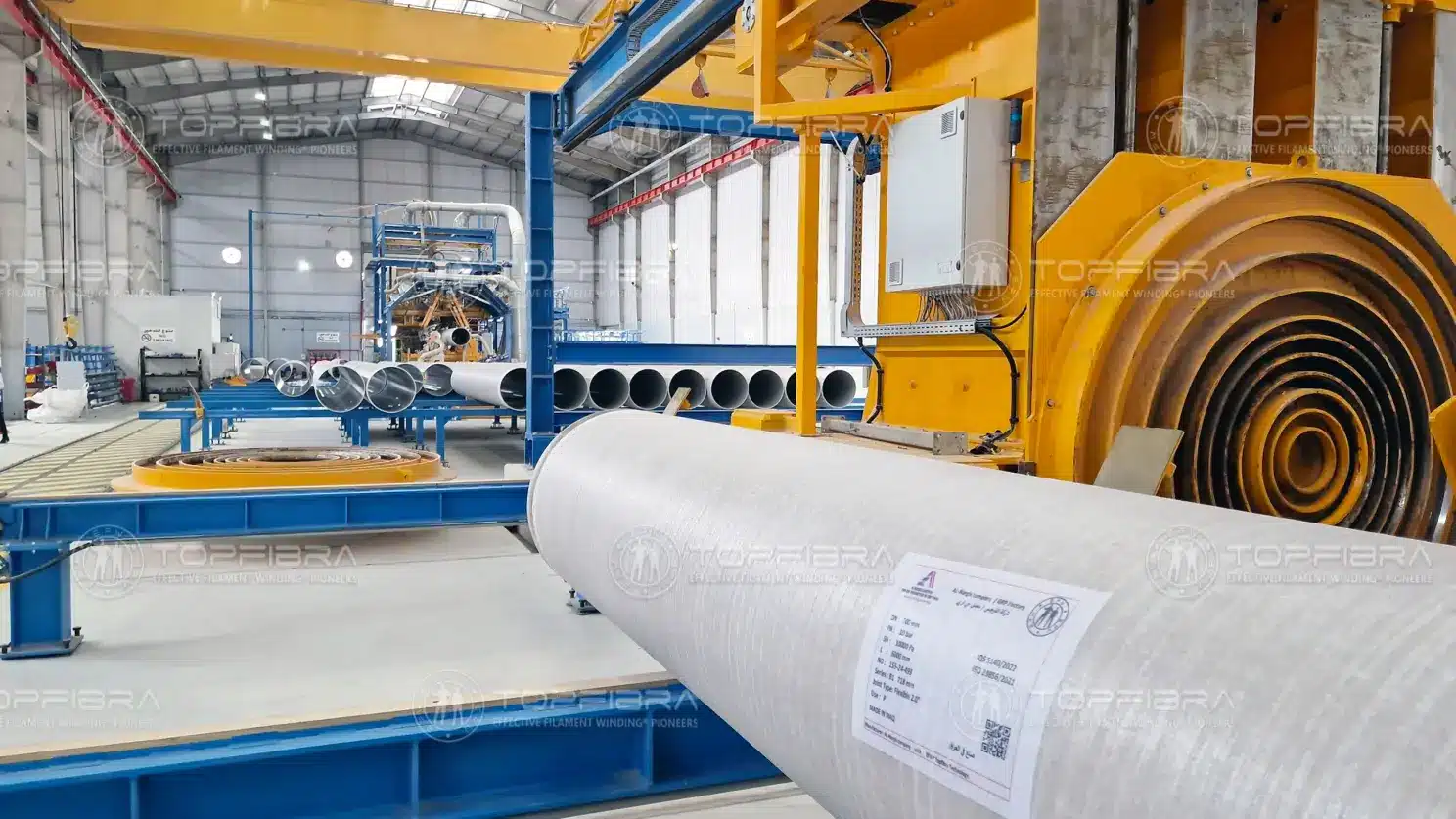 GRP pipe production line with filament winding machines and finished composite pipes